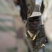 A Soldier Works with Teammates to Disassemble Fuel Lines