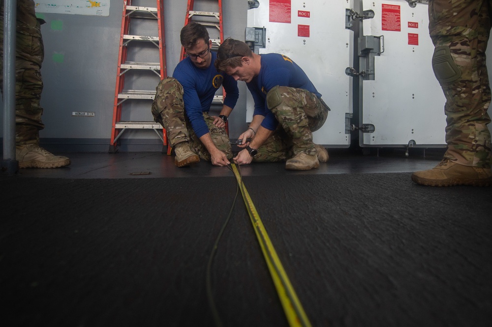 Explosive Ordnance Disposal Technician 2nd Class Kirk Chelsen, left, and Explosive Ordnance Disposal Technician 2nd Class Shane Gubbs measure detonation fuses during a training exercise on the fantail aboard USS John C. Stennis (CVN 74).