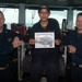 Seaman Apprentice Kassandra Lopez poses for a photograph as the Sailor of the Day with Capt. Randy Peck, right, commanding officer of USS John C. Stennis (CVN 74), and Command Master Chief Benjamin Rushing.