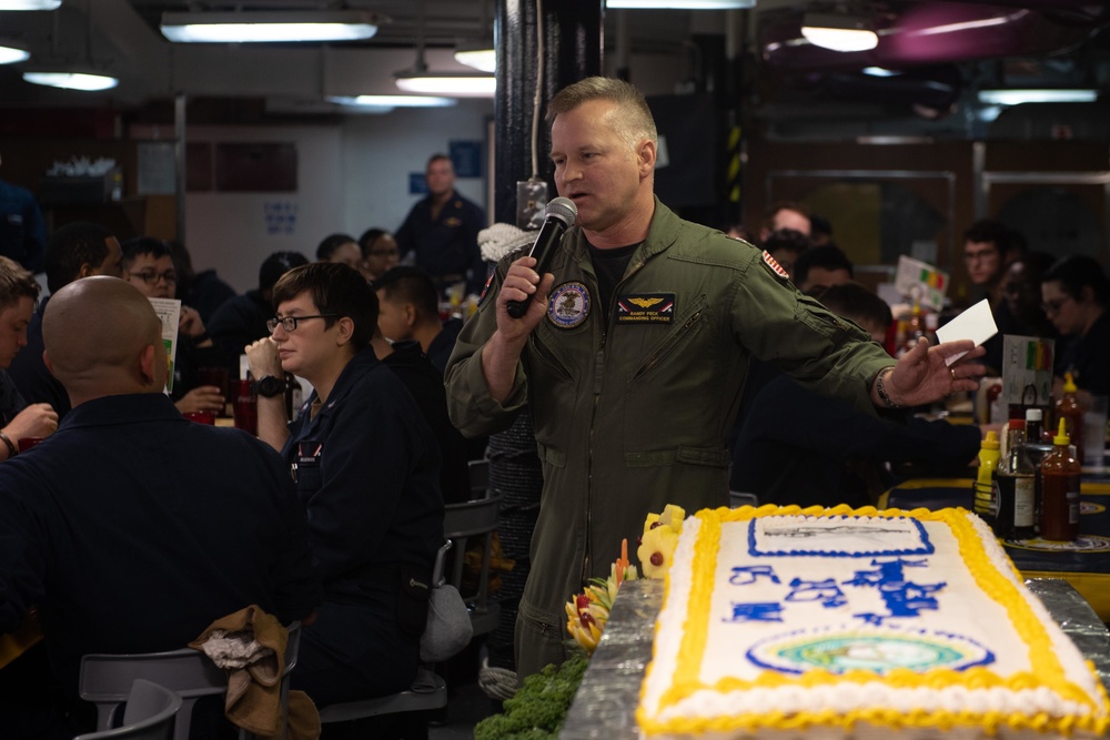 Capt. Randy Peck, commanding officer of USS John C. Stennis (CVN 74), addresses the ship's crew during a Navy birthday celebration on the mess decks.