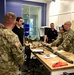 Soldier describes the uses, capabilities, and limitations of a field-expedient Braiser Breech device to Vanderbilt University ROTC cadre and Vanderbilt University Engineering Department staff