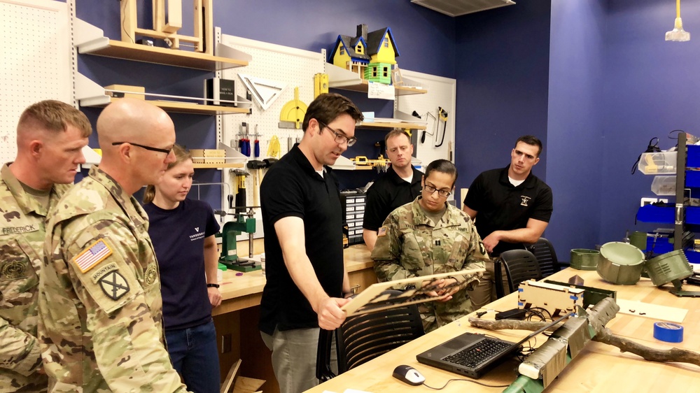 Vanderbilt University Research Assistant Professor explains the characteristics of laser-etched products to participants in the 3-D printing and laser etching exposition