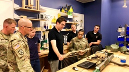 Vanderbilt University Research Assistant Professor explains the characteristics of laser-etched products to participants in the 3-D printing and laser etching exposition