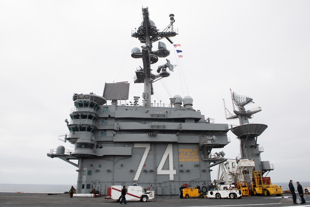 The Union Jack flies from the mast of USS John C. Stennis (CVN 74).