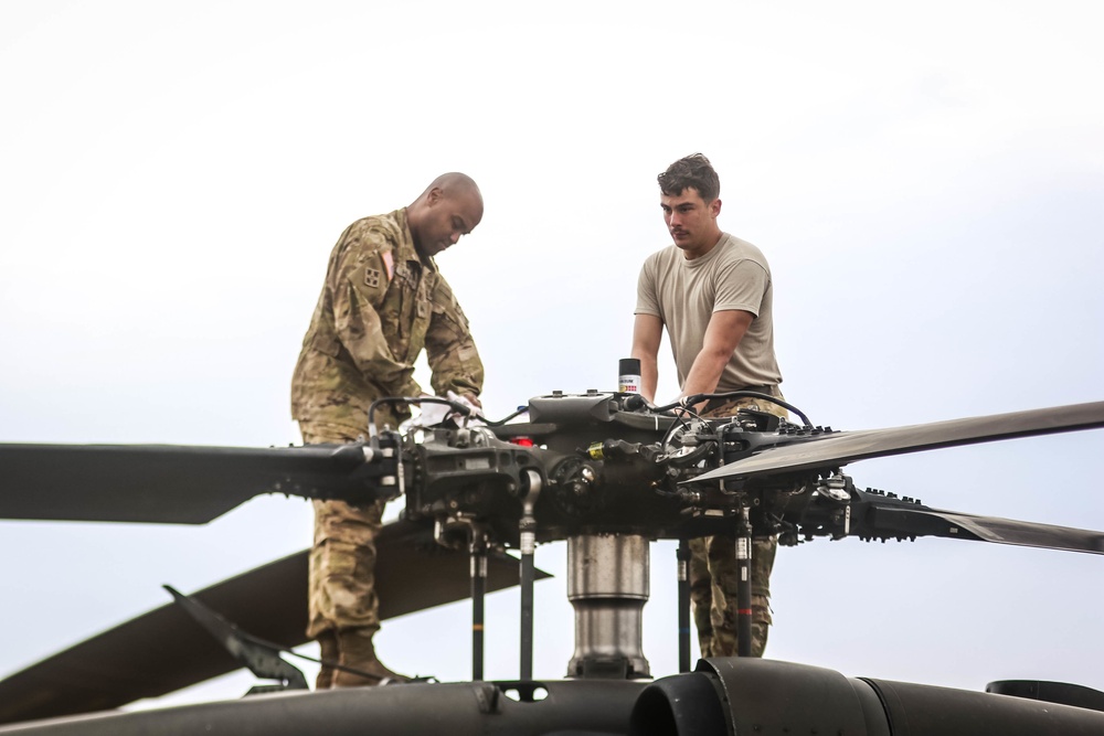 82nd CAB Crew Chief Checks Rotor Blades On A UH-60 Blackhawk Helicopter