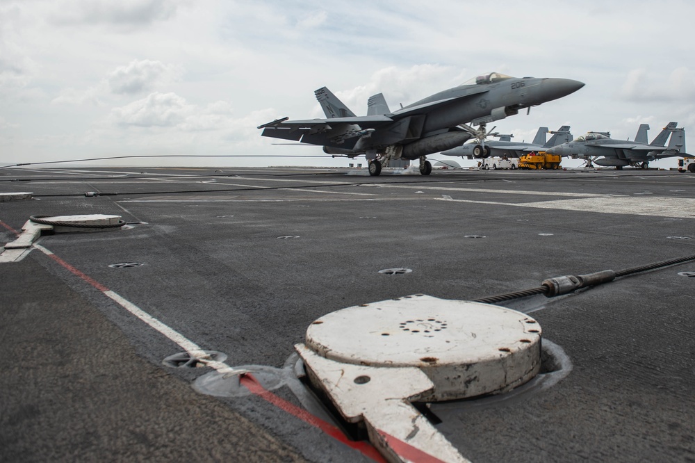 An F/A-18E Super Hornet, with Strike Fighter Squadron (VFA) 14, catches an arresting gear wire as it lands on the flight deck aboard the Nimitz-class aircraft carrier USS John C. Stennis (CVN 74).