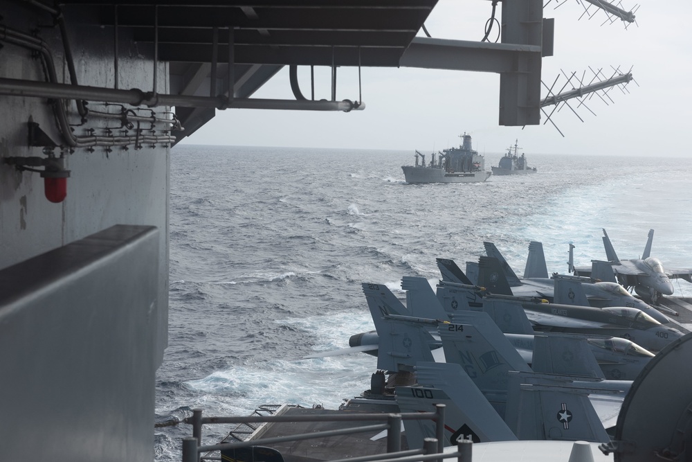 The fleet replenishment oiler USNS Guadalupe (T-AO 200) and the Ticonderoga-class guided-missile cruiser USS Mobile Bay (CG 53) sail behind the Nimitz-class aircraft carrier USS John C. Stennis (CVN 74) after a refueling-at-sea.