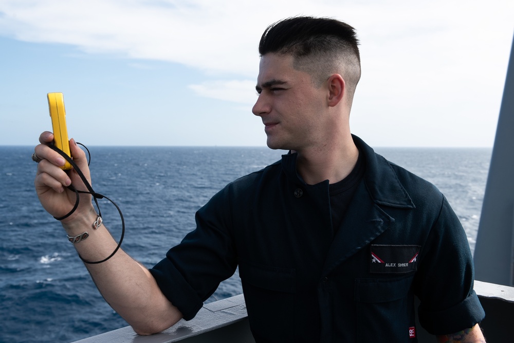 Aerographer’s Mate Airman Alex Shier, from Kansas City, Missouri, measures wind speed and outside temperatures on vulture’s row aboard the Nimitz-class aircraft carrier USS John C. Stennis (CVN 74).