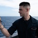 Aerographer’s Mate Airman Alex Shier, from Kansas City, Missouri, measures wind speed and outside temperatures on vulture’s row aboard the Nimitz-class aircraft carrier USS John C. Stennis (CVN 74).