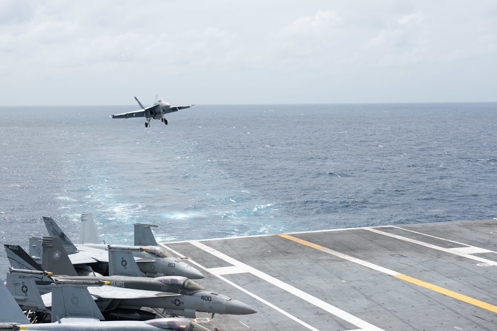 An F/A-18E Super Hornet, with Strike Fighter Squadron (VFA) 14, prepares to land on the flight deck aboard the Nimitz-class aircraft carrier USS John C. Stennis (CVN 74).