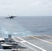 An F/A-18E Super Hornet, with Strike Fighter Squadron (VFA) 14, prepares to land on the flight deck aboard the Nimitz-class aircraft carrier USS John C. Stennis (CVN 74).