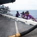 Sailors observe a fueling evolution on the flight deck aboard the Nimitz-class aircraft carrier USS John C. Stennis (CVN 74).