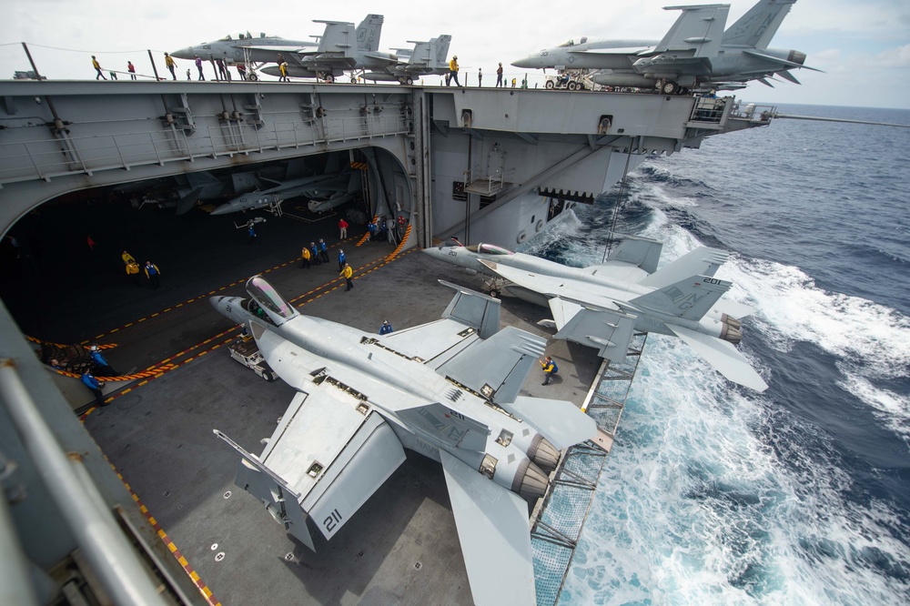 Sailors direct F/A-18E Super Hornets, with Strike Fighter Squadron (VFA) 14, onto an aircraft elevator aboard the Nimitz-class aircraft carrier USS John C. Stennis (CVN 74).