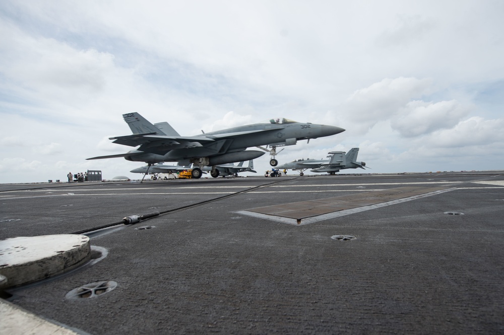 An F/A-18E Super Hornet, with Strike Fighter Squadron (VFA) 97, catches an arresting gear wire as it lands on the flight deck aboard the Nimitz-class aircraft carrier USS John C. Stennis (CVN 74).