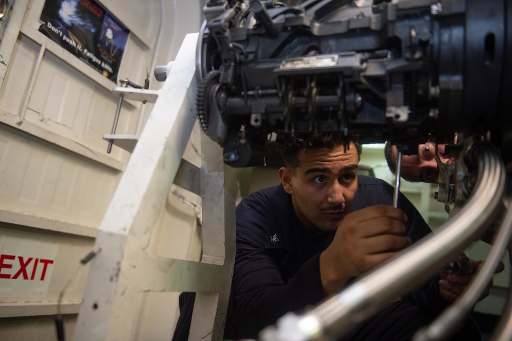 Aviation Ordnanceman 3rd Class George Moreno, from San Diego, performs maintenance on an M61A-2 20mm machine gun aboard the Nimitz-class aircraft carrier USS John C. Stennis (CVN 74).