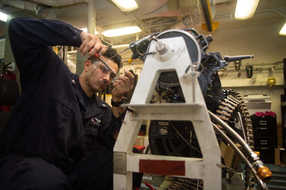 Aviation Ordnanceman 3rd Class George Moreno, from San Diego, performs maintenance on an M61A-2 20mm machine gun aboard the Nimitz-class aircraft carrier USS John C. Stennis (CVN 74).