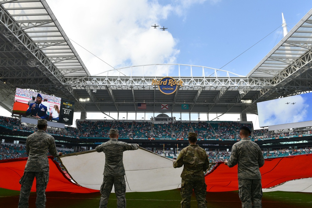 45th SW Airmen unfurl flag at Miami Dolphins game