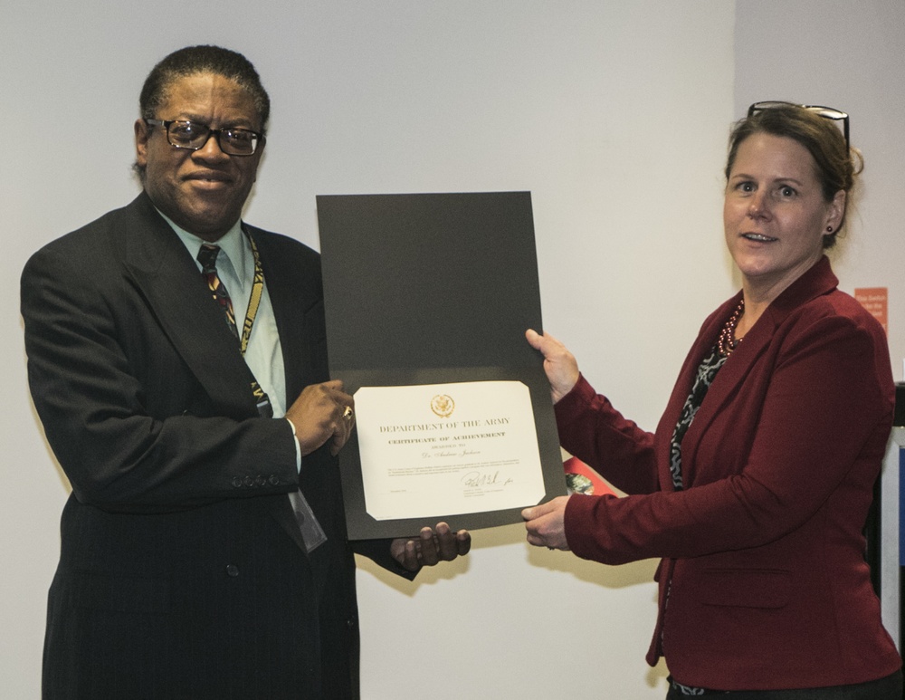 Deb Czombel awards Dr. Andrew Jackson with a Certificate of Achievement
