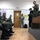 Maryland Guard, Bosnia-Herzegovina armed forces celebrate 15-year partnership A military briefing or training session is taking place indoors, with a female soldier in woodland camouflage uniform standing on an elevated platform and addressing a group of seated military personnel. The audience includes soldiers wearing different camouflage patterns, some displaying what appears to be a Bosnian flag patch on their sleeves. A second standing individual in a different uniform pattern holds papers near the back of the room.
