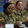 Maryland Guard, Bosnia-Herzegovina armed forces celebrate 15-year partnership A group of U.S. Army soldiers in OCP (Operational Camouflage Pattern) uniforms are seated at a conference table, appearing to attend a formal military briefing or meeting. The foreground soldier displays a U.S. flag patch and an 'ARMY' tape, with a partially visible name tape reading 'BIRD' followed by additional letters. The setting appears to be an official military conference room with a banner visible in the background.