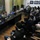 Maryland Guard, Bosnia-Herzegovina armed forces celebrate 15-year partnership Two female military personnel in camouflage uniforms are seated at a large dark conference table, addressing a group of approximately 20-25 young civilians seated in rows facing them. The setting appears to be an official meeting room or briefing space, likely at a cultural or educational institution. The event appears to be a community outreach or informational session between military representatives and young civilians.