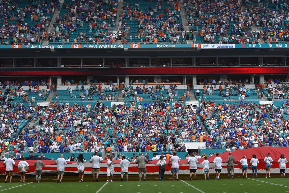 45th SW Airmen unfurl flag at Miami Dolphins game