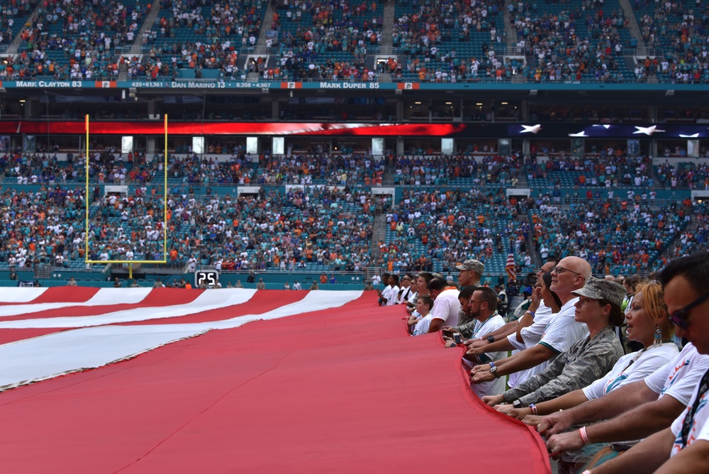 45th SW Airmen unfurl flag at Miami Dolphins game