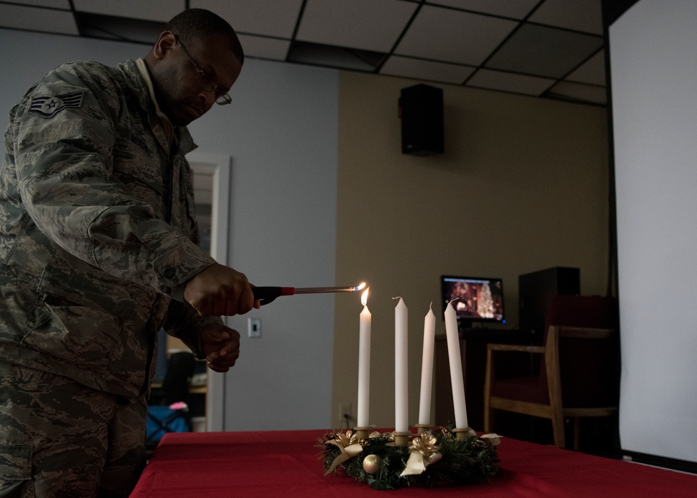 Airmen light candles as a way to remember, symbol of hope