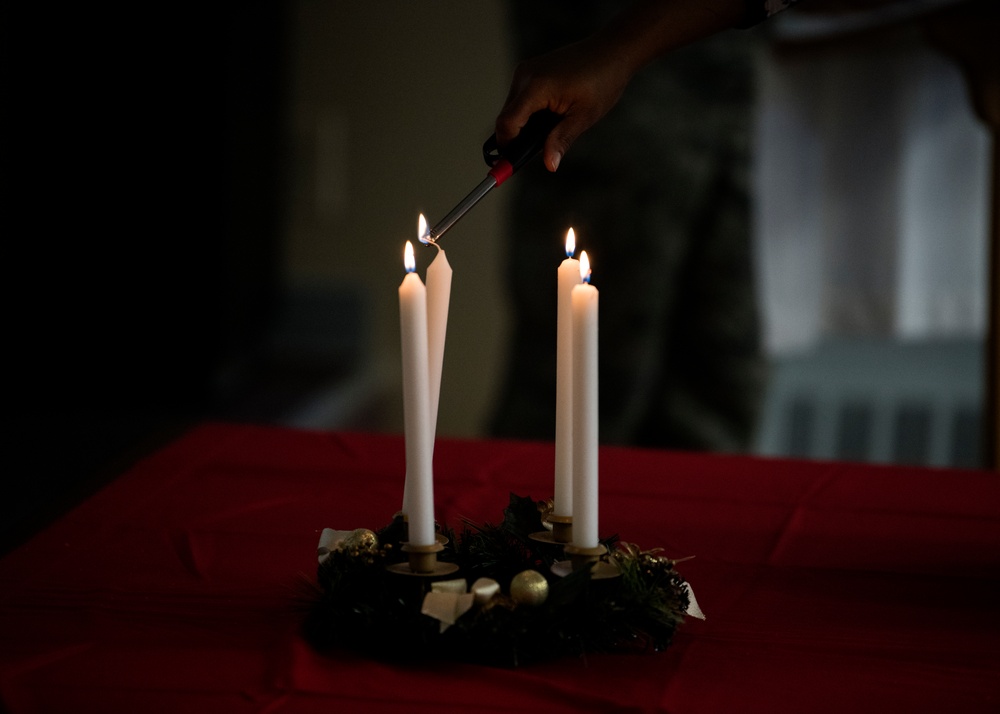 Airmen light candles as a way to remember, symbol of hope