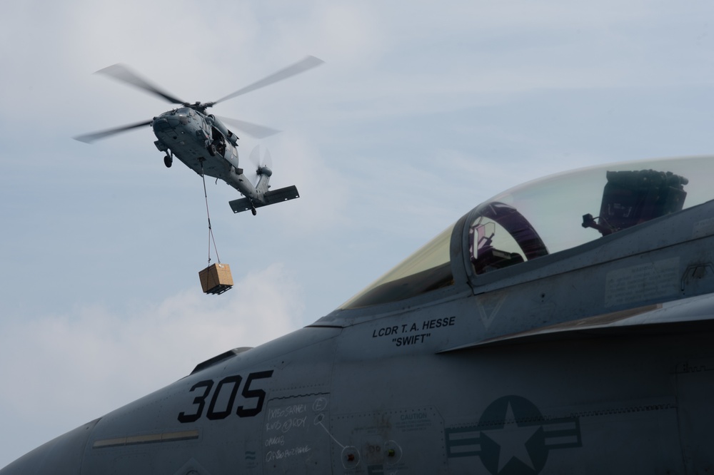 An MH-60S Knight Hawk, with Helicopter Sea Combat Squadron (HSC) 14, delivers ammunition to the flight deck of the Nimitz-class aircraft carrier USS John C. Stennis (CVN 74) during a vertical replenishment.