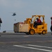 Sailors conduct an ammunition onload on the flight deck during a vertical replenishment aboard the Nimitz-class aircraft carrier USS John C. Stennis (CVN 74).