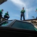 Sailors direct the elevation of an Integrated Catapult Control Station from the flight deck aboard the Nimitz-class aircraft carrier USS John C. Stennis (CVN 74).