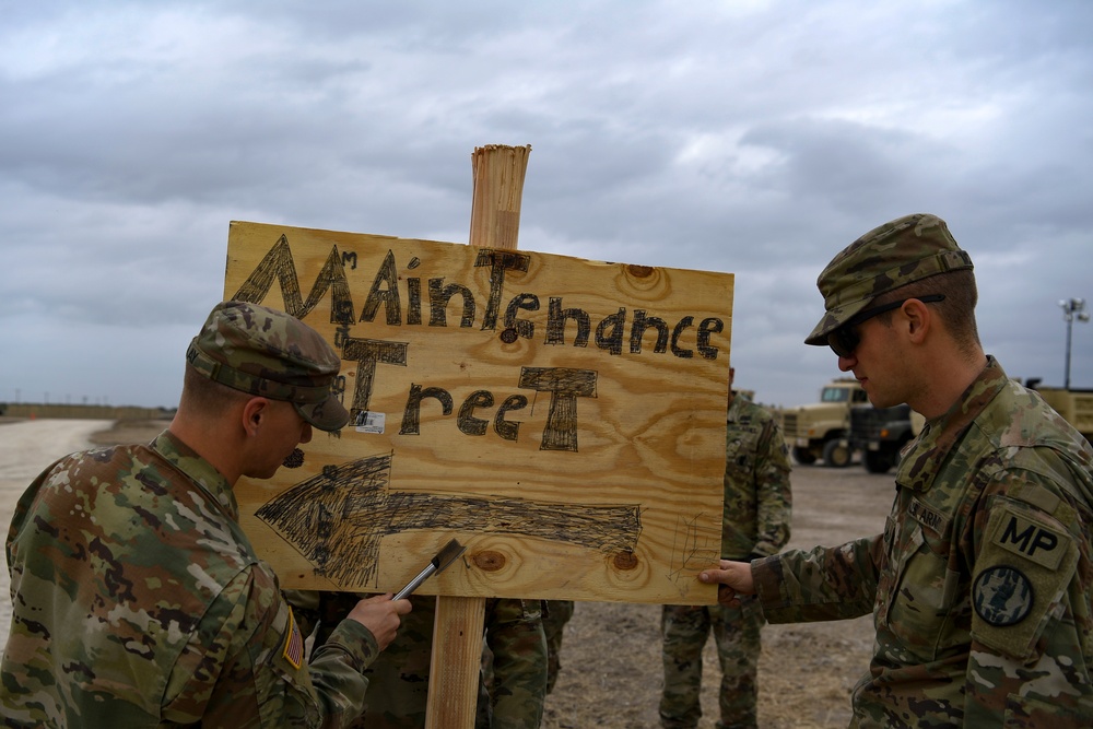 Army Soldiers post signs around Camp Donna