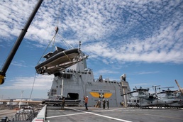 USS Green Bay loads USCG boats