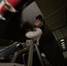 U.S. Navy Sailor conduct maintenance on an E-2C Hawkeye