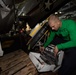 U.S. Navy Sailor conducts maintenance on an E-2C Hawkeye