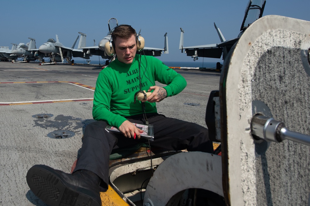 U.S. Navy Sailor conducts maintenance on the flight deck