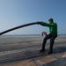 U.S. Navy Sailor places slot seal on steam-powered catapult