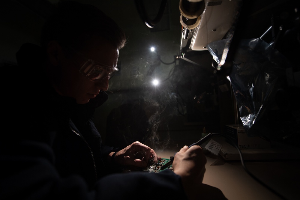 Aviation Electronics Technician Airman Adam Slakes, from Holland, Michigan, replaces components on a circuit board aboard the Nimitz-class aircraft carrier USS John C. Stennis (CVN 74).