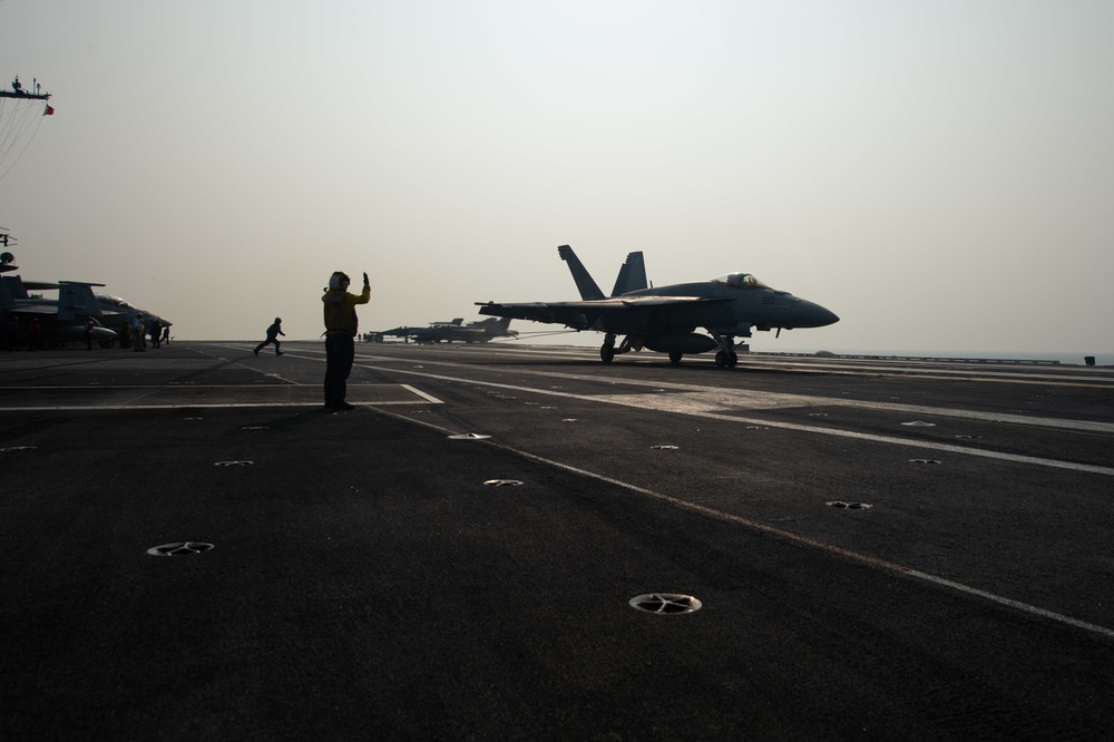 An F/A-18E Super Hornet, with Strike Fighter Squadron (VFA) 14, lands on the flight deck aboard the Nimitz-class aircraft carrier USS John C. Stennis (CVN 74).