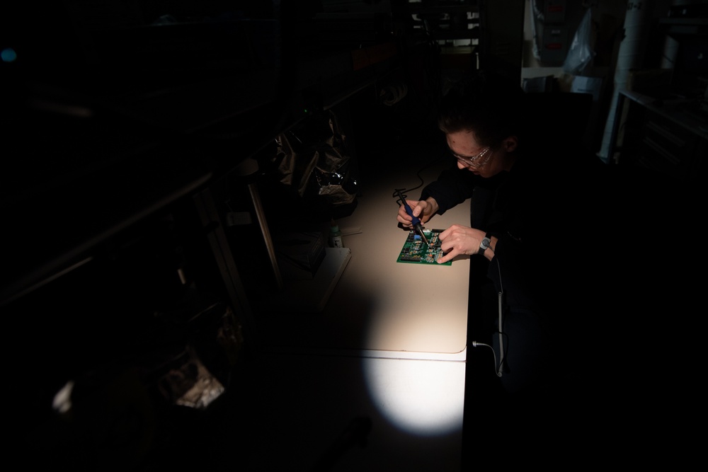 Aviation Electronics Technician Airman Adam Slakes, from Holland, Michigan, replaces components on a circuit board aboard the Nimitz-class aircraft carrier USS John C. Stennis (CVN 74).