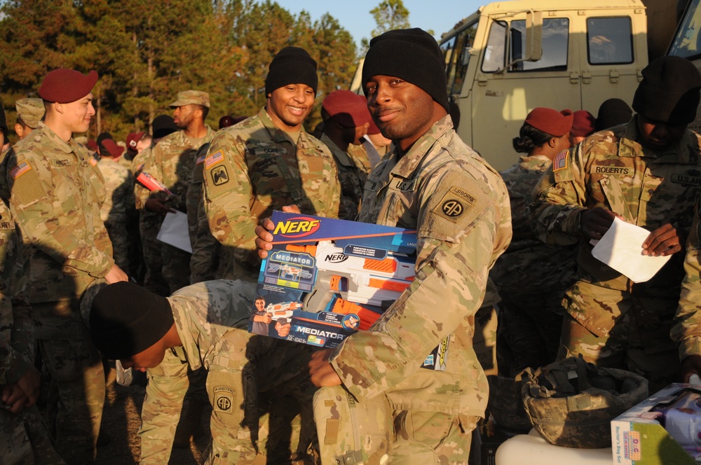 Soldiers line up to draw jump lottery ticket; drop toys