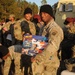 Soldiers line up to draw jump lottery ticket; drop toys