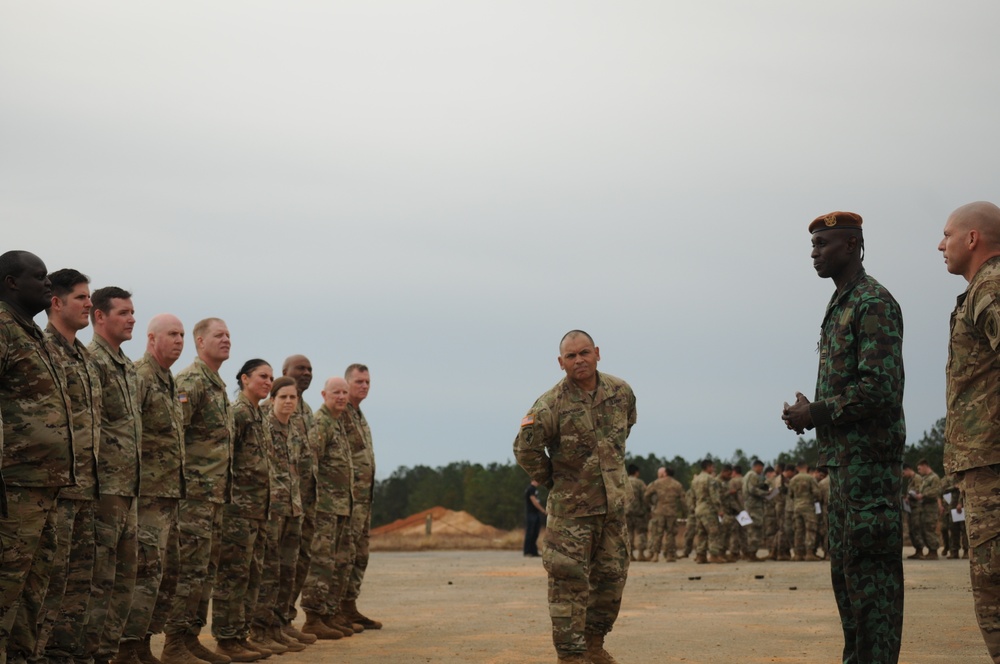 Cote d'Ivoire Army Jumpmaster congratulates U.S. paratroopers at OTD XXI