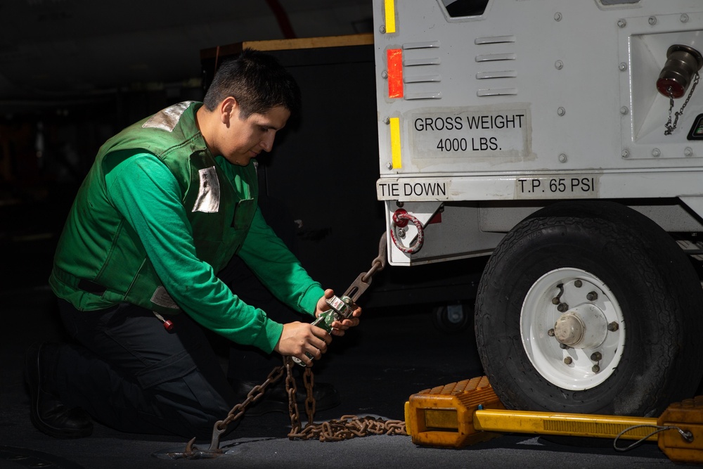 U.S. Navy Sailor conducts maintenance in hangar bay