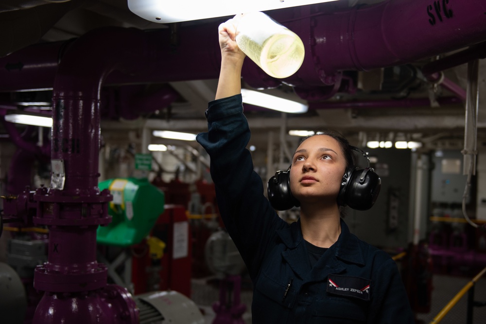 U.S. Navy Sailor inspects jet fuel