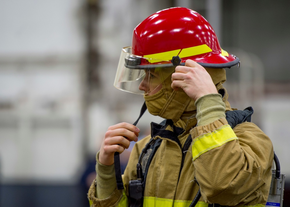 GHWB Sailor Dons Fire Fighting Equipment