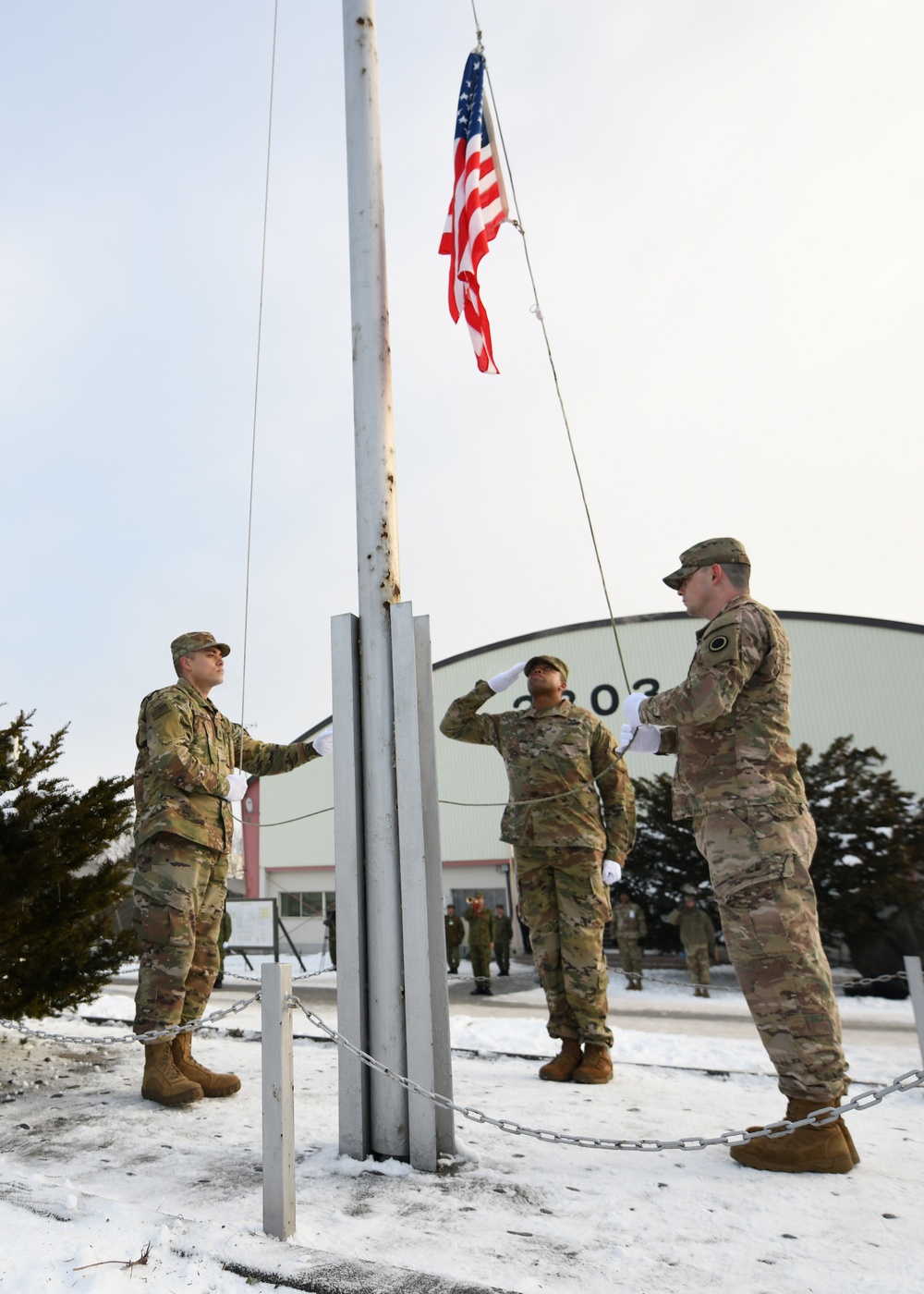 U.S. Army soldiers participate in a flag raising ceremony