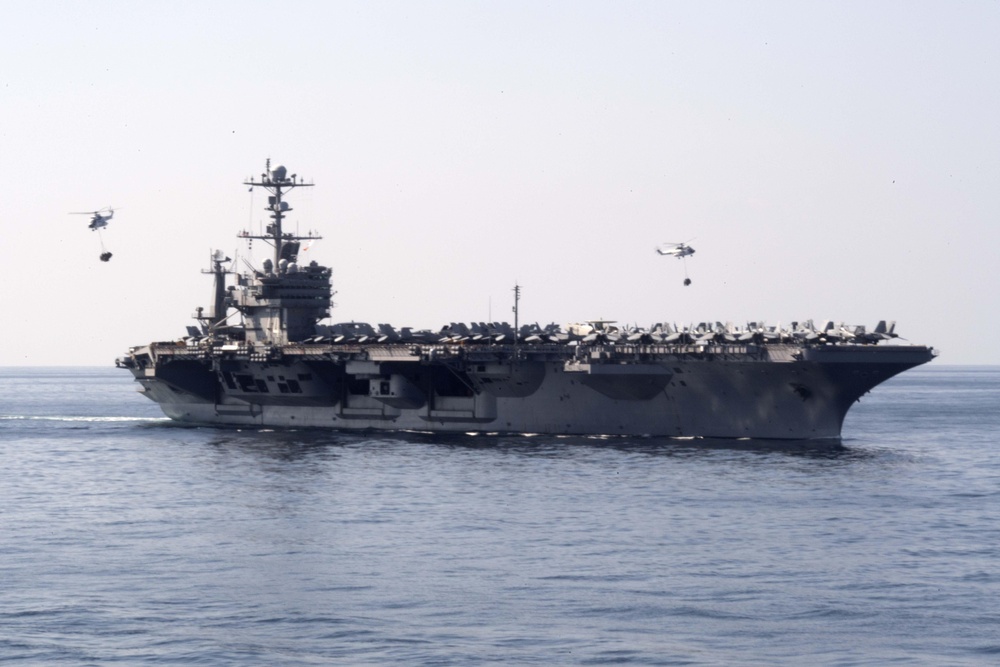 Two SA-330 Puma helicopters transport supplies between the aircraft carrier USS John C. Stennis (CVN 74)