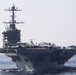 An SA-330 Puma helicopters lowers supplies onto the flight deck of the aircraft carrier USS John C. Stennis (CVN 74)